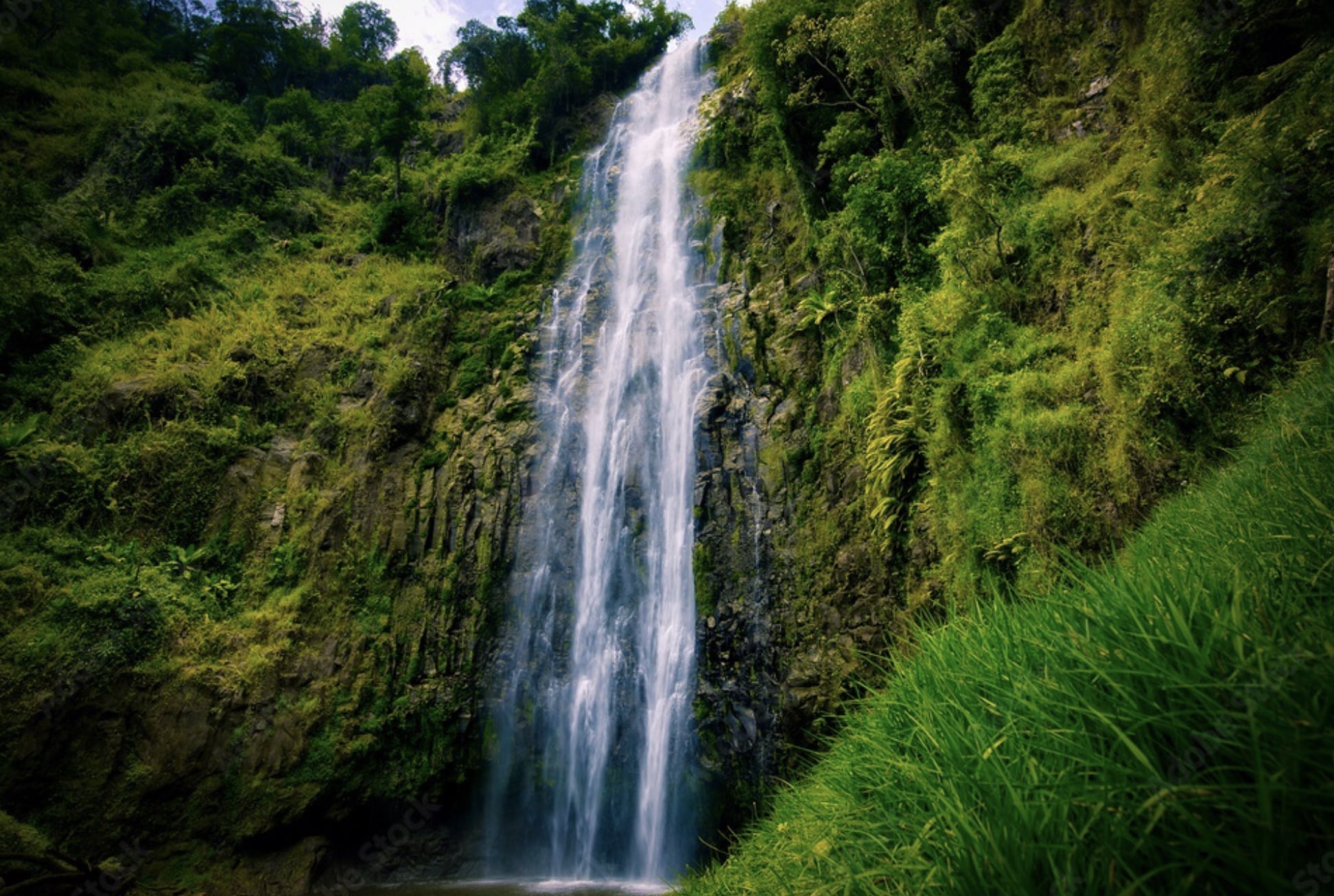 Travelers hiking to Materuni Waterfalls and experiencing local village culture in Tanzania.